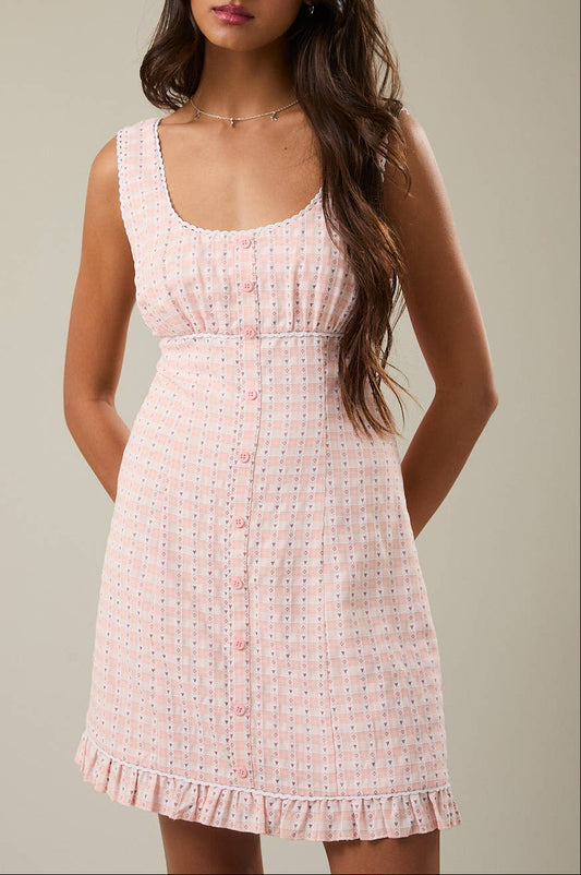 Woman wearing a pink dress against a neutral background
