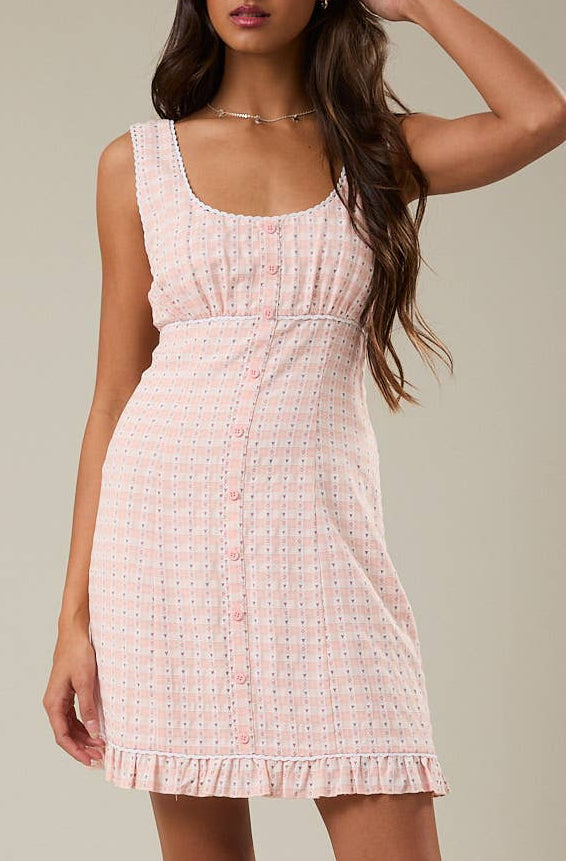 Woman wearing a pink dress against a plain background