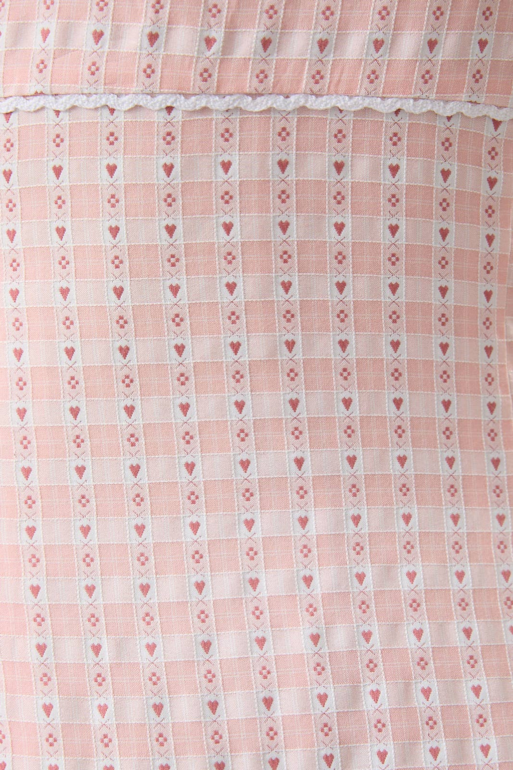 Close-up of a pink fabric with heart and diamond pattern