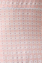 Close-up of a pink fabric with heart and diamond pattern