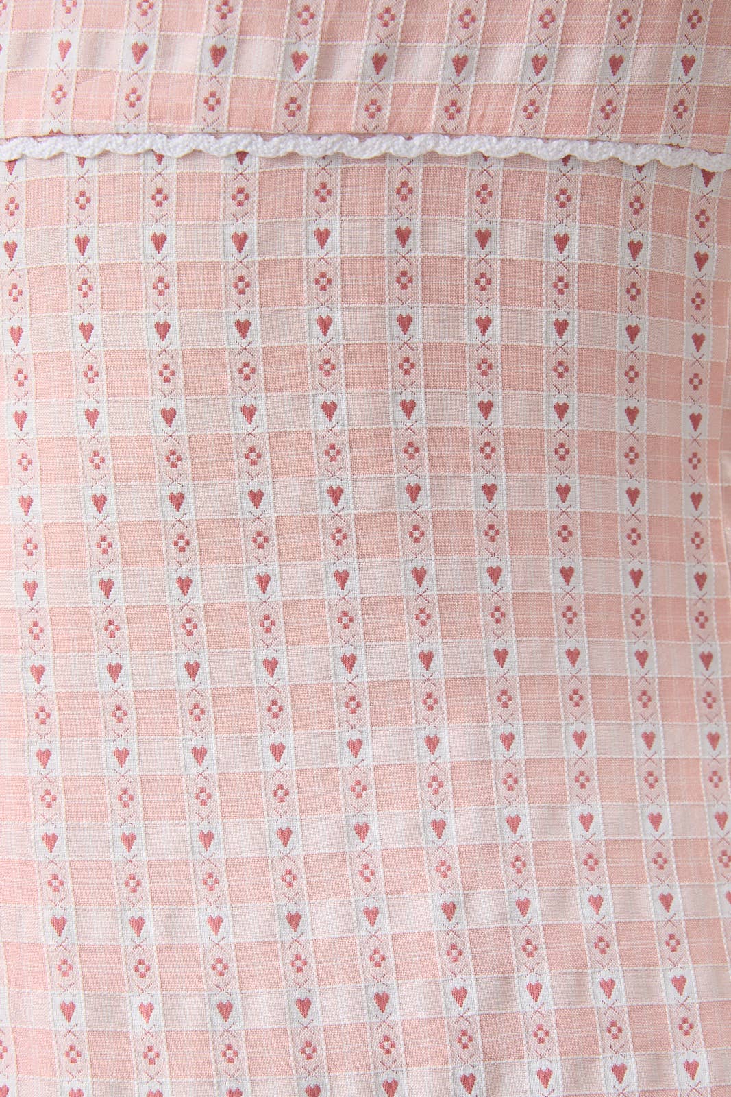 Close-up of a pink fabric with heart and diamond pattern