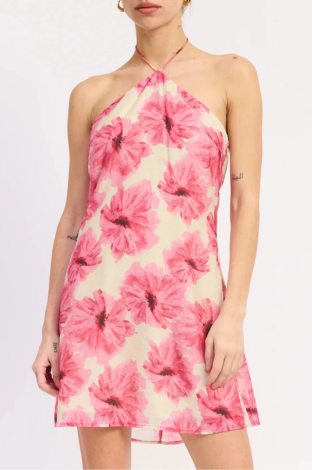 Woman wearing a pink floral dress on a white background