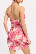 Woman wearing a pink and white tie-dye dress on a white background