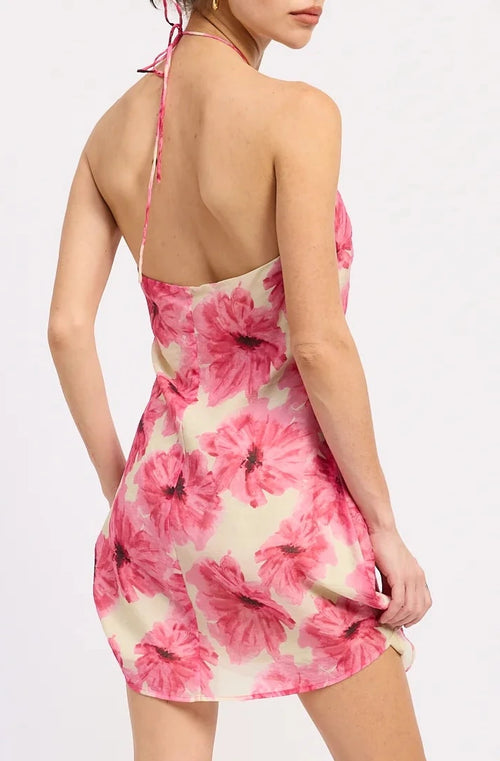 Woman wearing a pink and white tie-dye dress on a white background