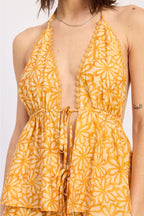 Yellow floral patterned halter on a plain background