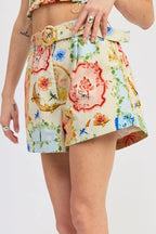 Woman wearing a colorful floral skirt on a white background