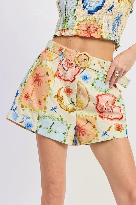 Woman wearing a colorful floral two-piece outfit on a white background