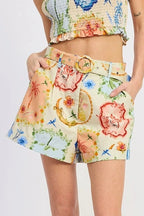 Woman wearing a colorful floral outfit on a white background