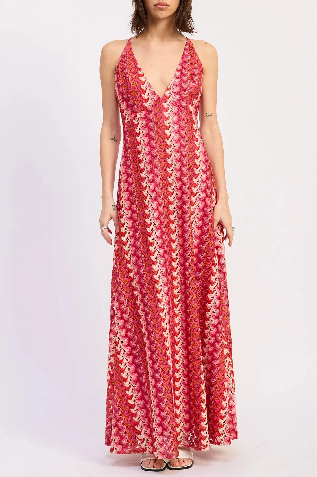 Woman wearing a red patterned dress on a white background