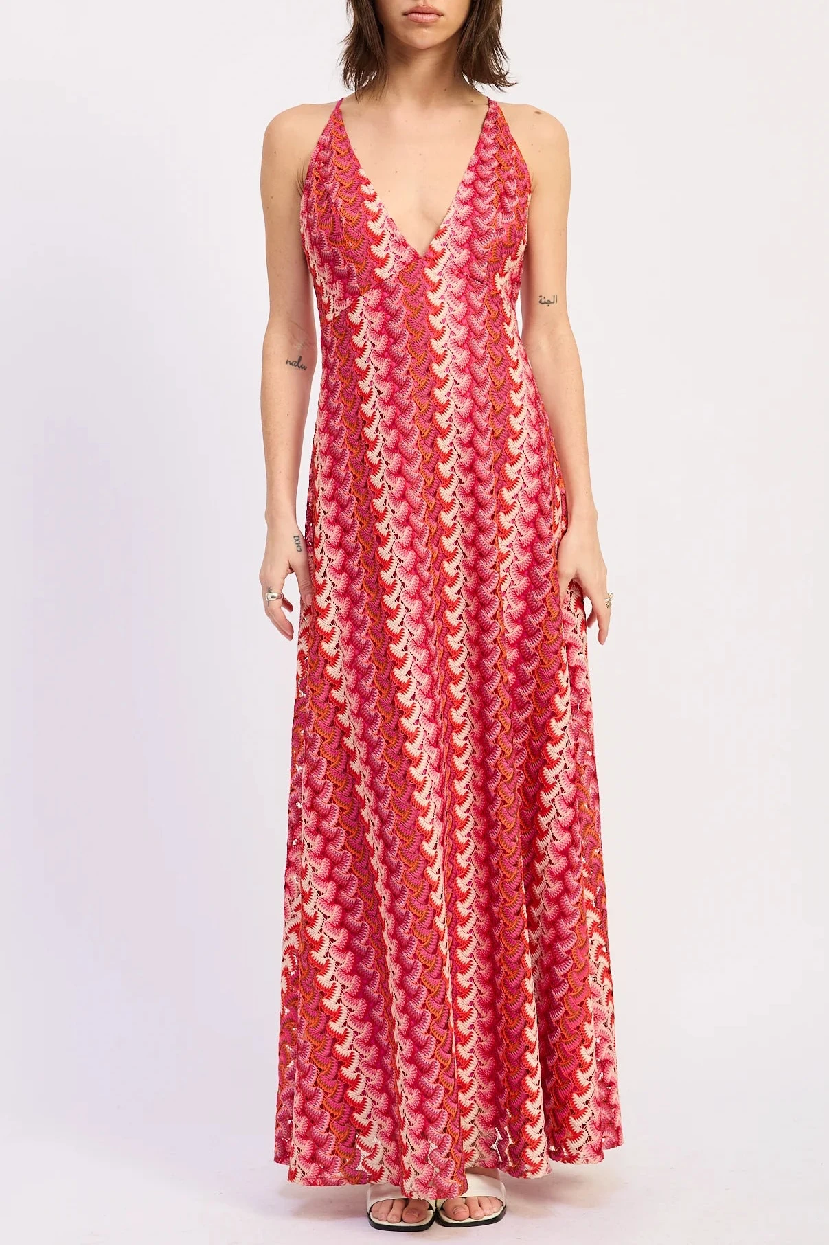 Woman wearing a red patterned dress on a white background
