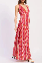Woman wearing a red patterned dress on a white background