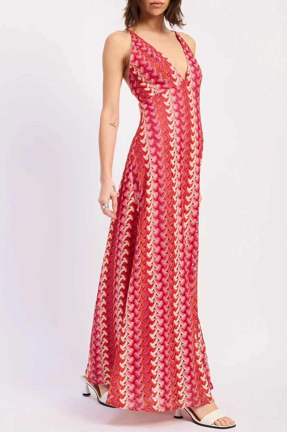Woman wearing a red patterned dress on a white background