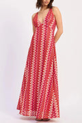 Woman wearing a red patterned dress on a white background