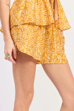 Person wearing a yellow floral short