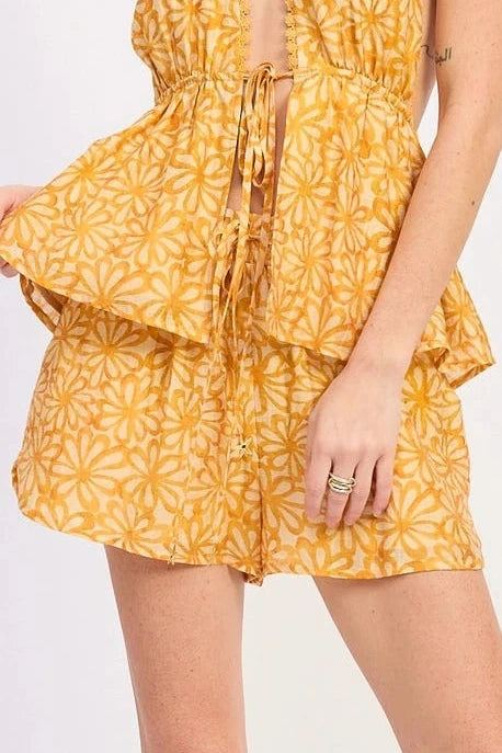 Woman wearing a yellow floral short on a white background