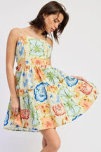 Woman wearing a colorful floral dress on a white background