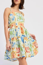 Woman wearing a colorful floral dress on a white background