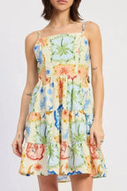 Woman wearing a colorful floral dress on a white background