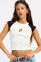 Woman wearing a white and black crop top and light blue jeans on a white background