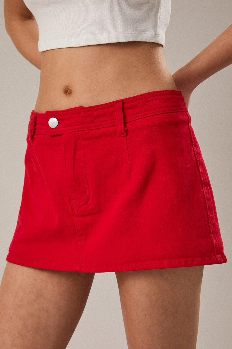 Red skirt worn by a person on a neutral background