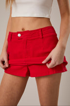 Red shorts worn by a person on a neutral background