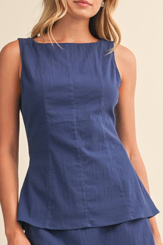 Woman wearing a blue dress against a beige background