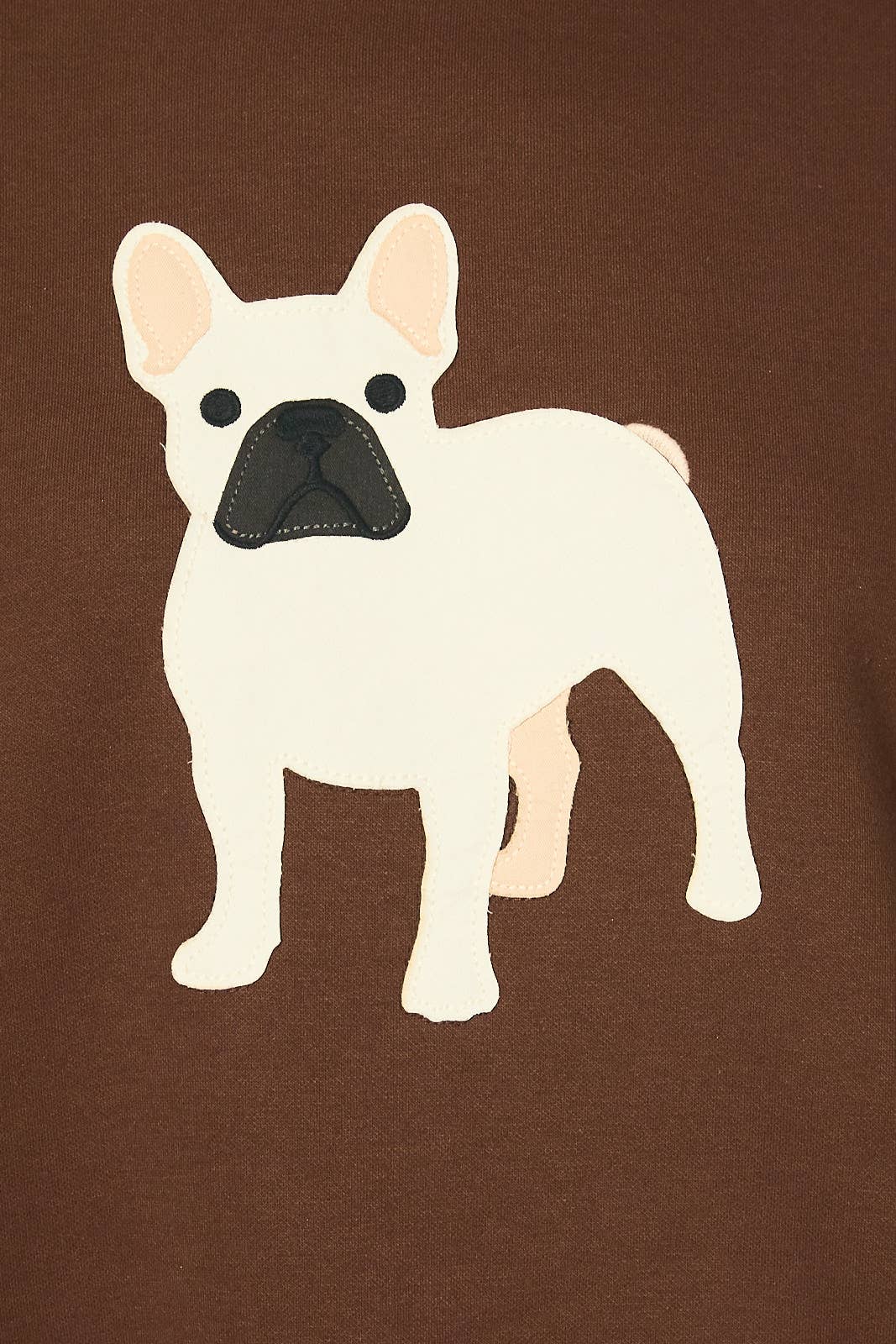A cream-colored French Bulldog graphic with a black snout and pink inner ears, printed on a solid brown fabric background.