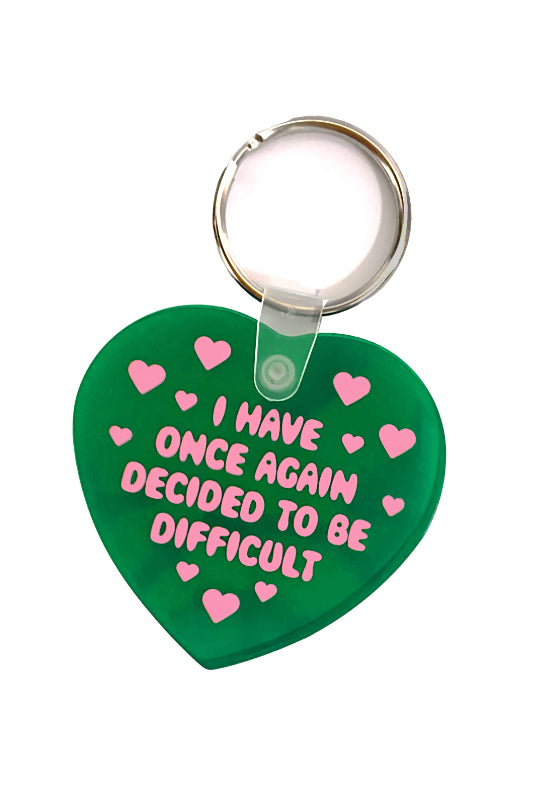 Heart-shaped keychain with pink text and hearts on a green background
