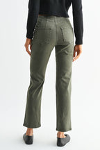 A woman shown from the back wearing a black long-sleeve cropped top and olive green straight-leg jeans, paired with black flats, against a plain white studio background.