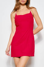 Woman wearing a red dress against a white background
