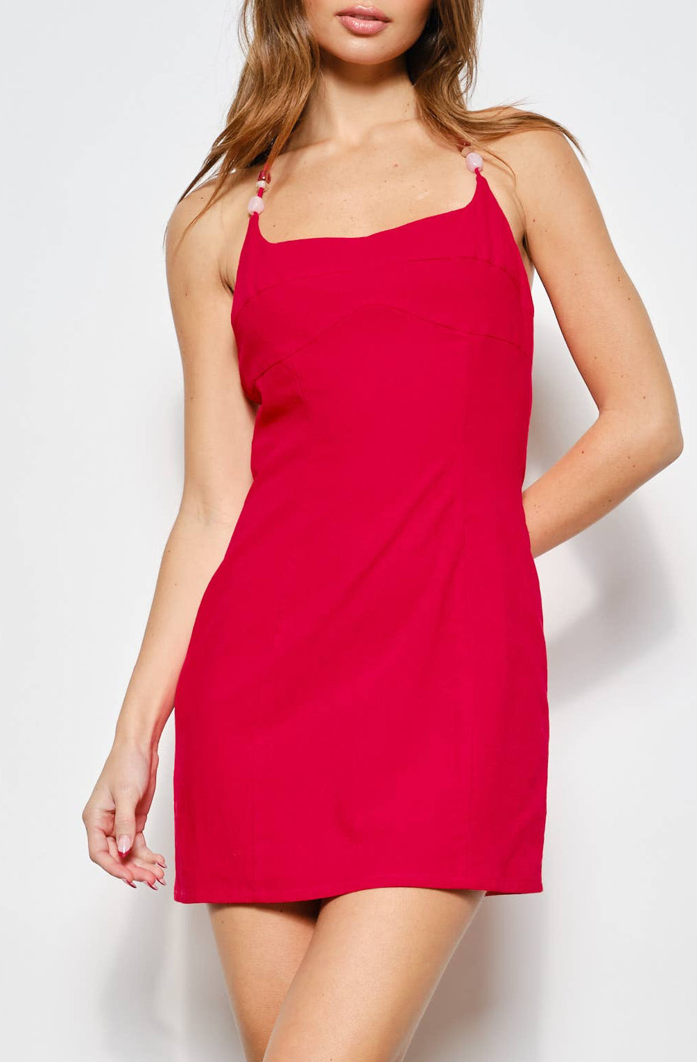 Woman wearing a red dress against a white background