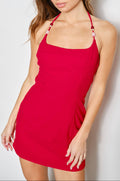 Woman wearing a red dress against a plain background