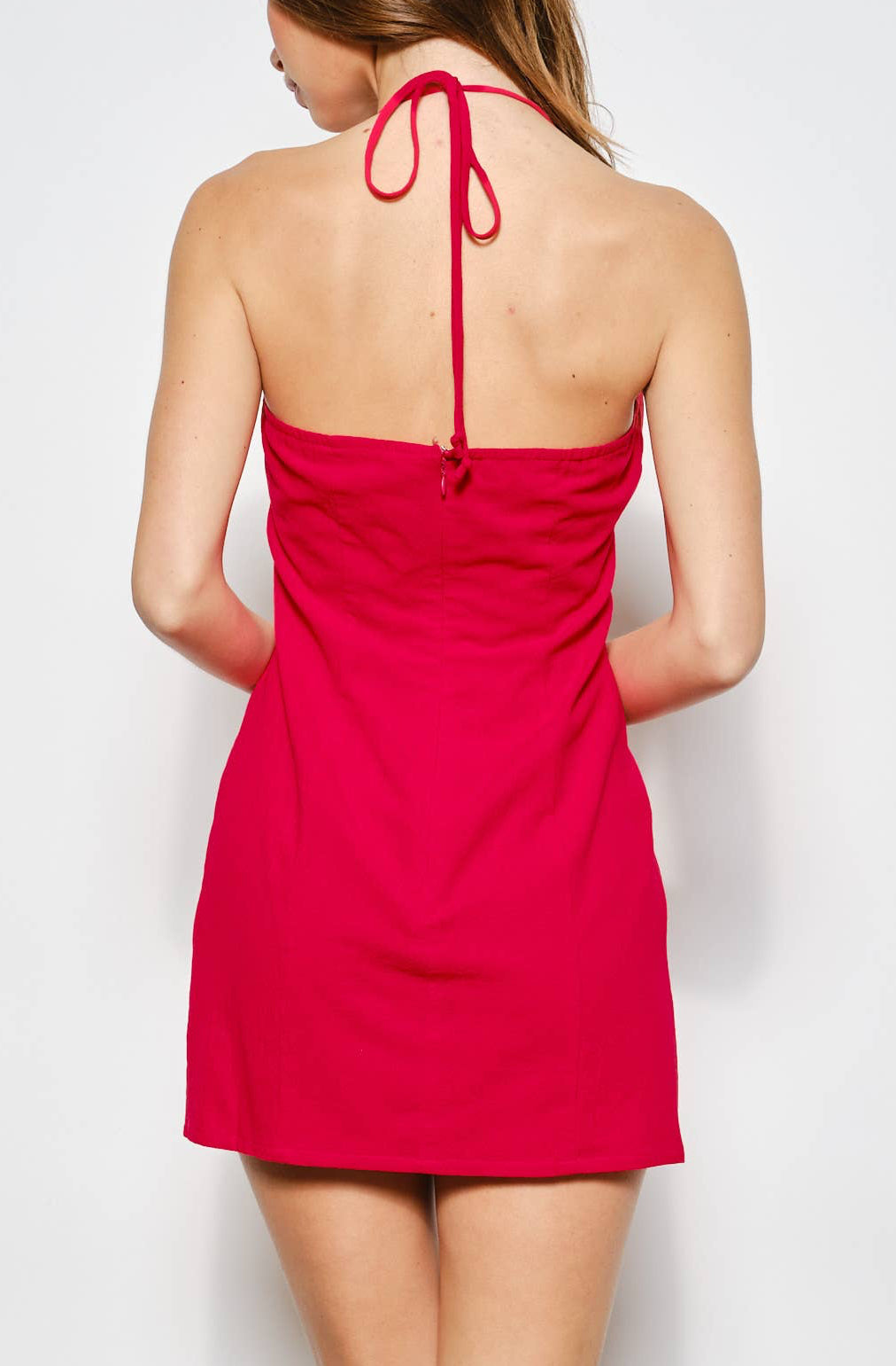Woman wearing a red dress against a white background