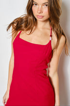 Woman wearing a red dress against a plain background
