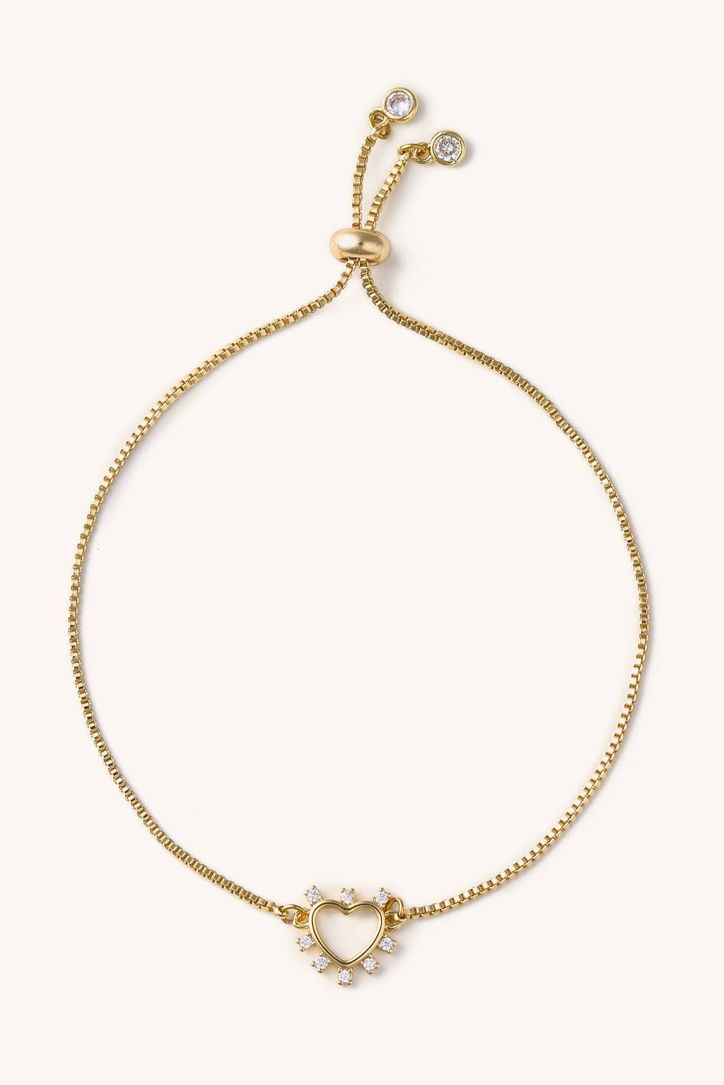 Gold bracelet with heart-shaped clasp on a white background