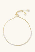 Gold bracelet with small diamonds on a white background