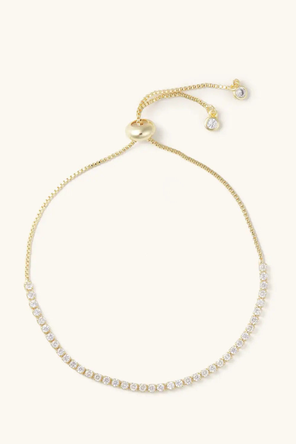 Gold bracelet with small diamonds on a white background