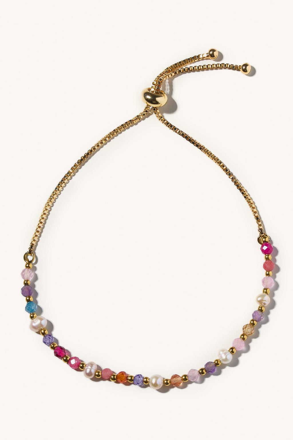 Multicolored beaded bracelet with gold chain on a white background