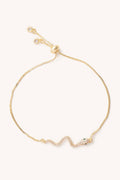 Gold bracelet with snake on a white background