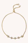 Gold bracelet with small diamonds on a white background