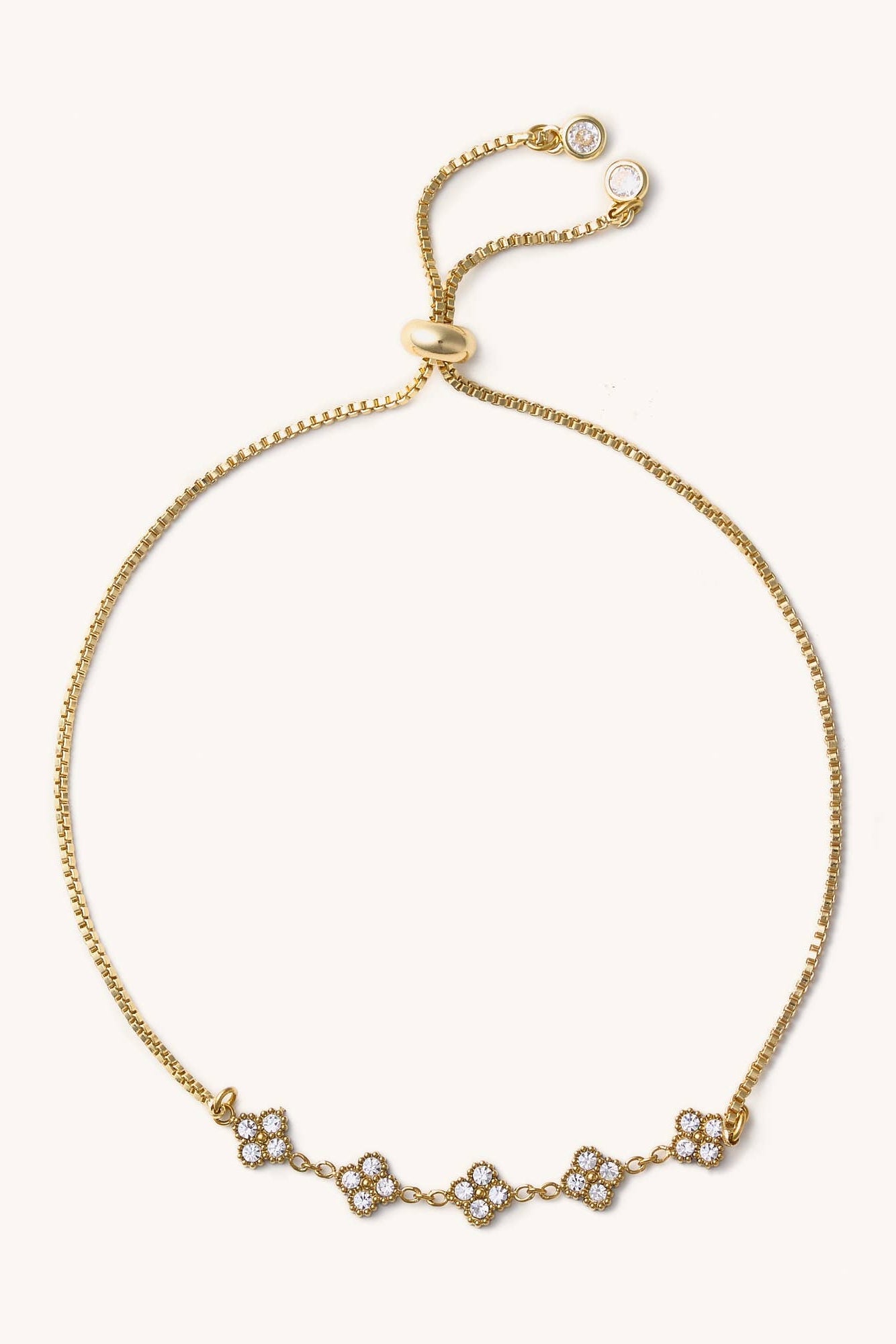 Gold bracelet with small diamonds on a white background