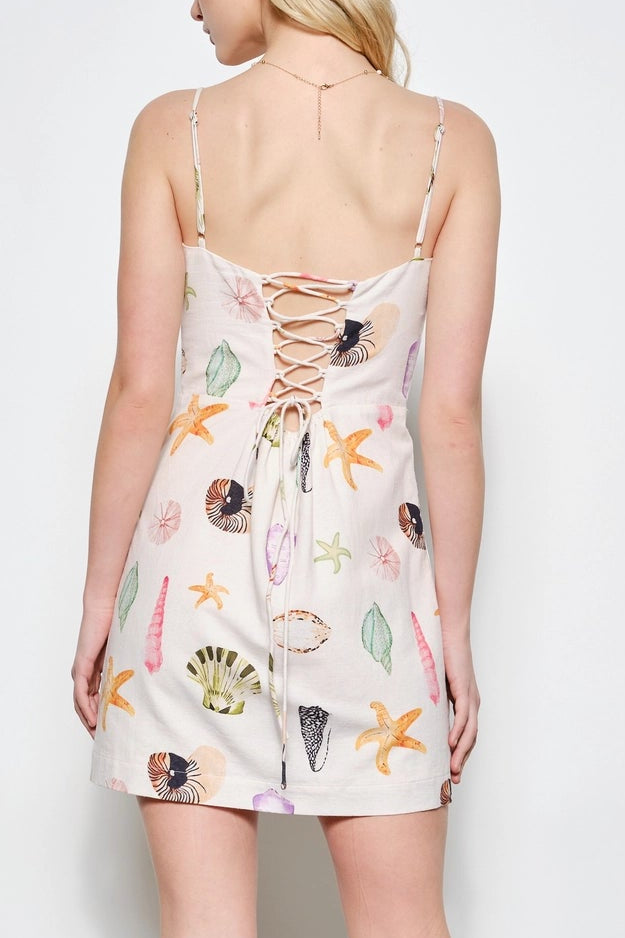 Woman wearing a floral dress against a white background
