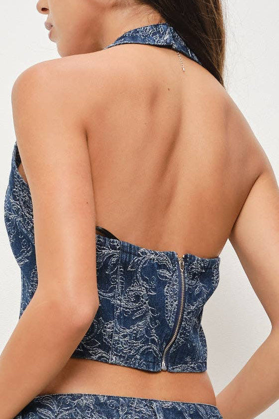 Woman wearing a blue paisley jumpsuit on a white background