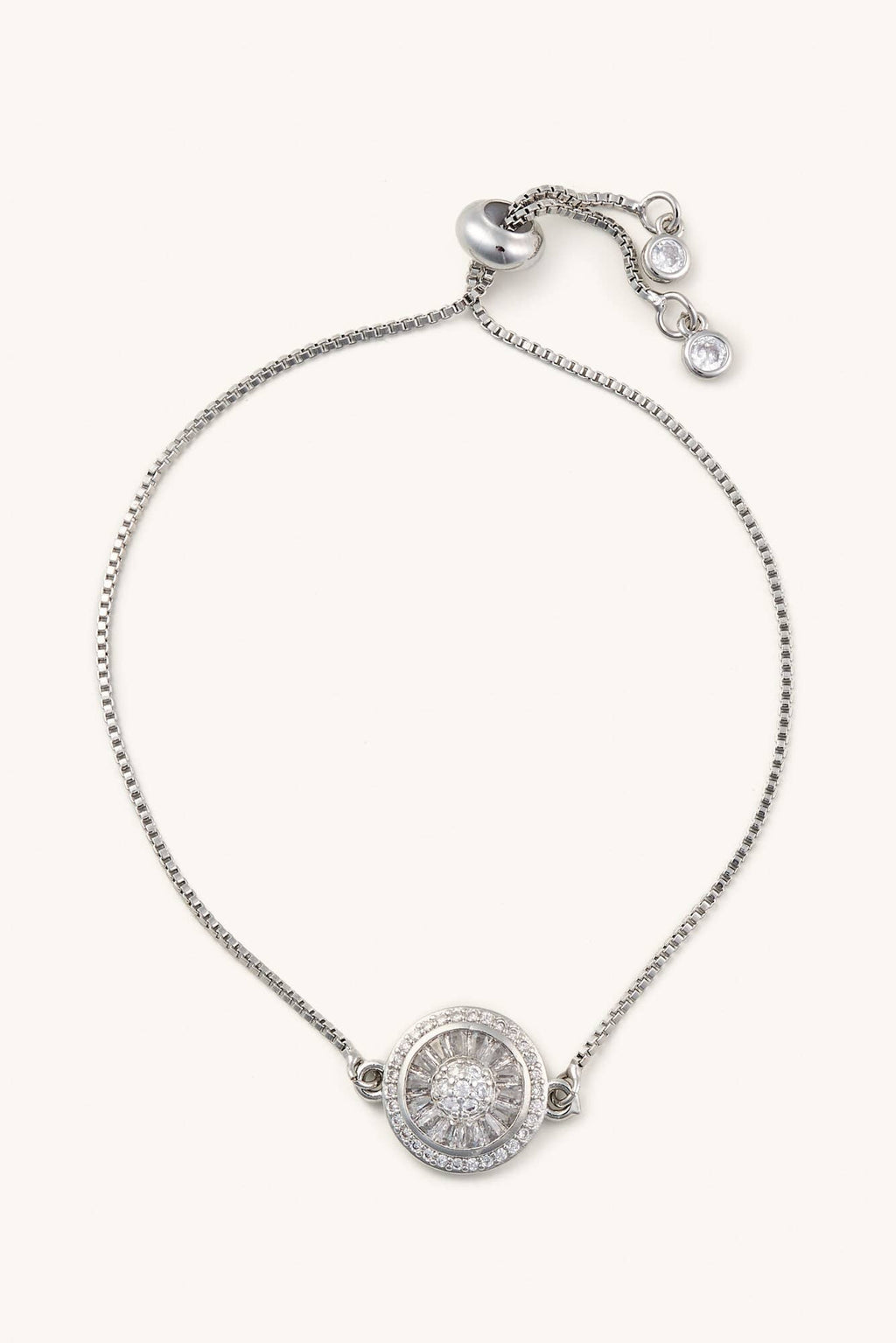 Silver bracelet with a round pendant on a white background