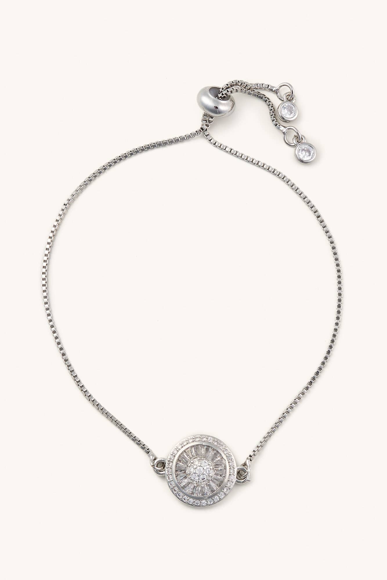 Silver bracelet with a round pendant on a white background