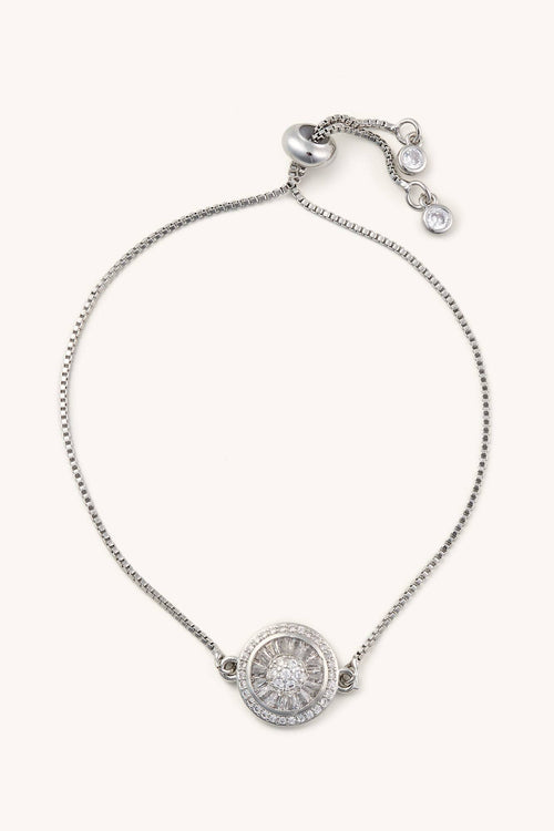 Silver bracelet with a round pendant on a white background