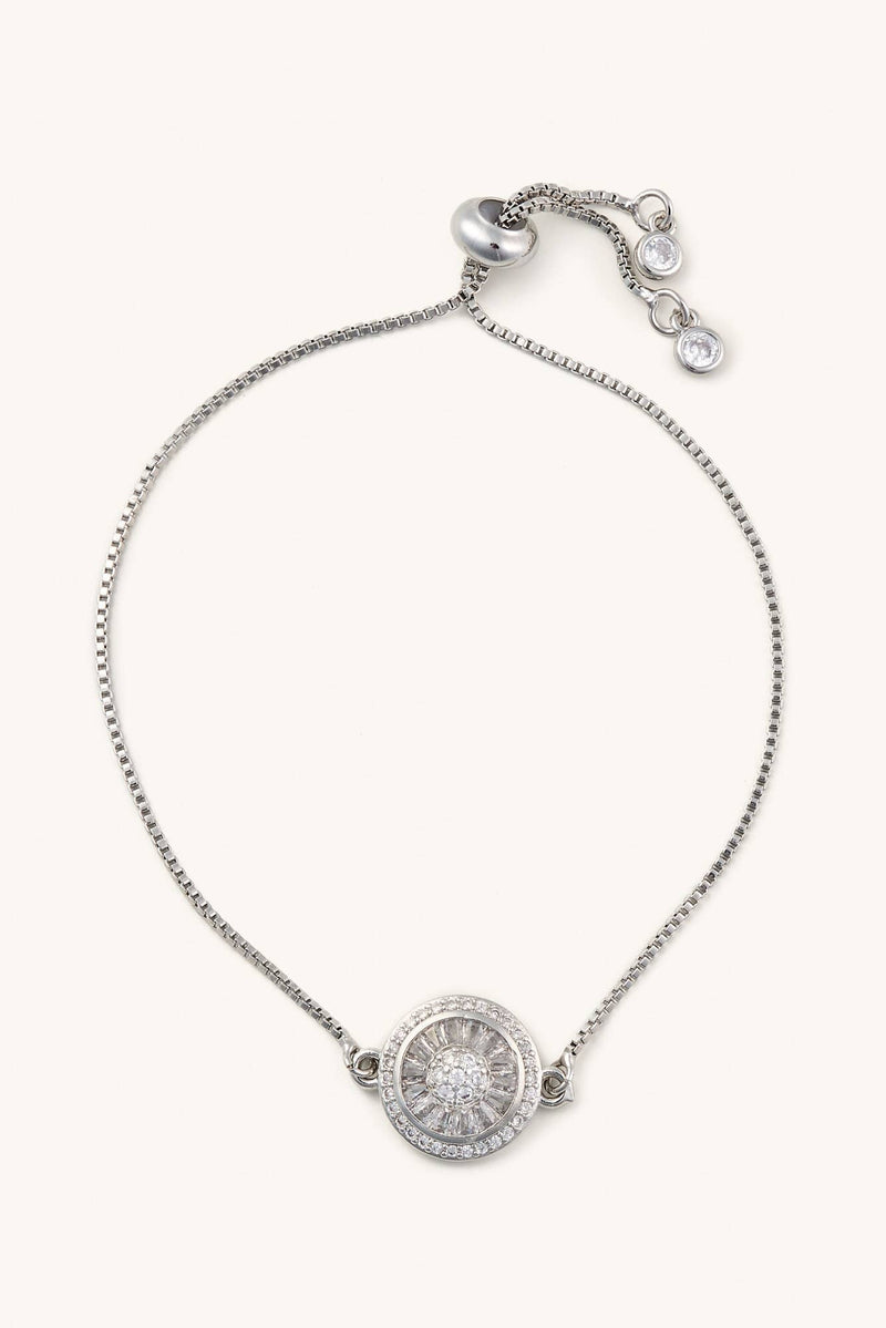 Silver bracelet with a round pendant on a white background