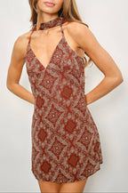 Woman wearing a patterned dress against a white background