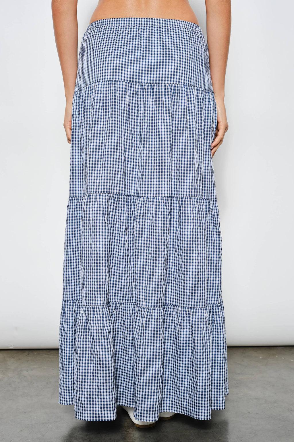Long blue and white checkered skirt on a plain background