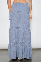 Long blue and white checkered skirt on a plain background